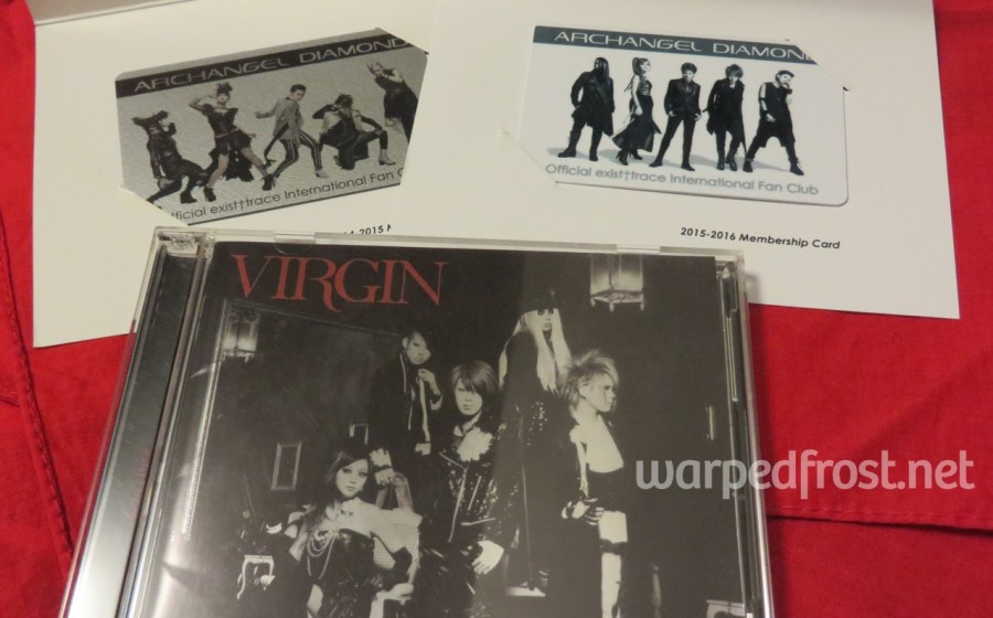 Photo of the first pressing edition of the exist trace album VIRGIN in the foreground. In the background are my old membership cards to the international fanclub Archangel Diamond.
