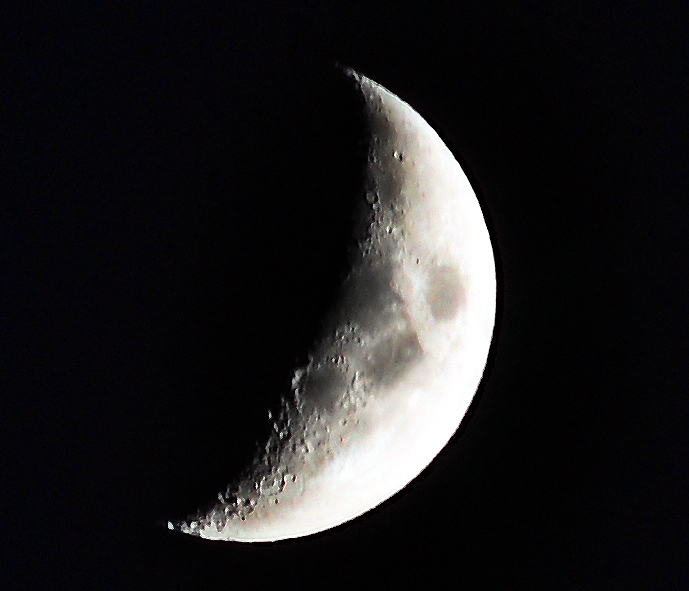 Photo of a crescent moon close to setting