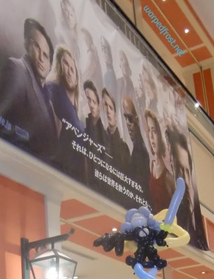 Balloon Seph with a large theatrical poster for the first Avengers movie