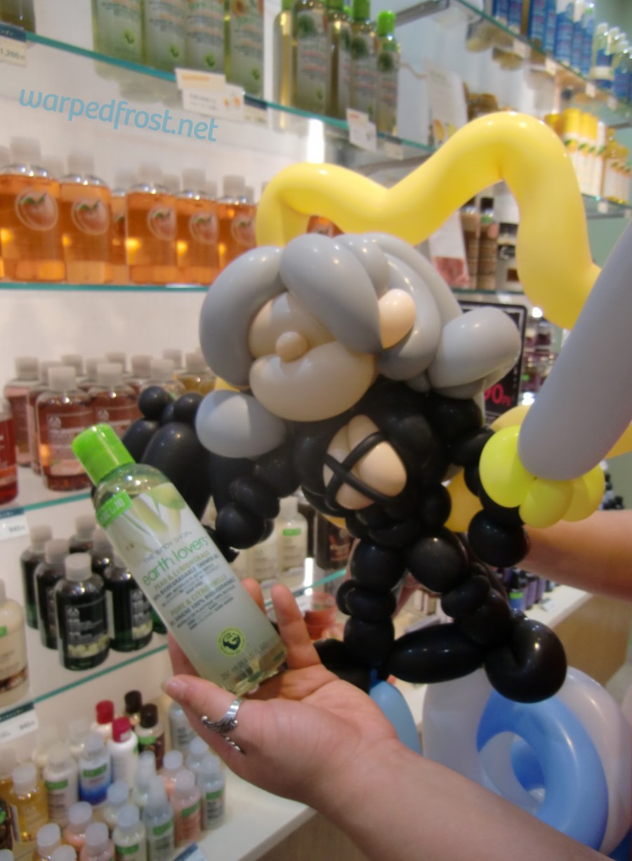 Balloon Seph looking at a body wash in The Body Shop