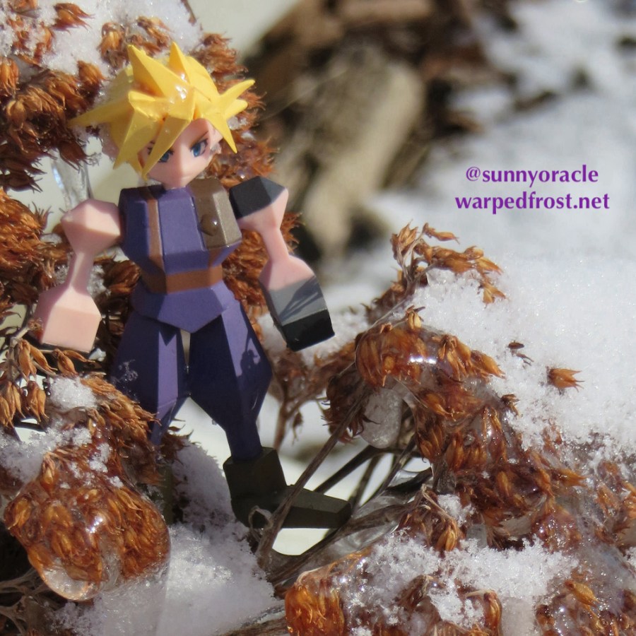 Cloud Strife Polygon Figure sitting in a dried sedum that is covered in snow and icicles
