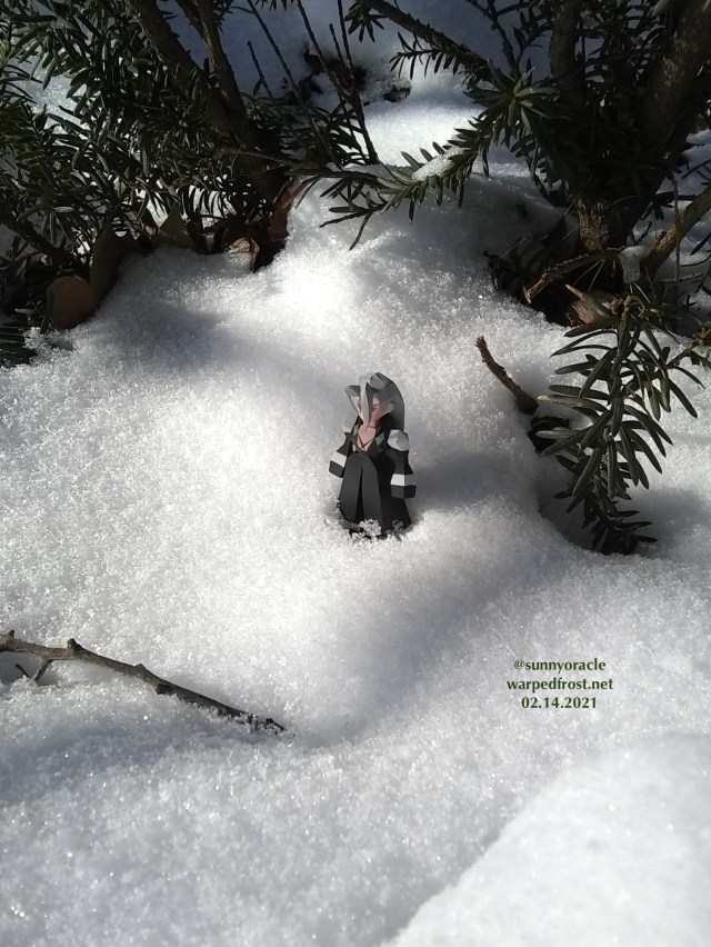 The Sephiroth Polygon figure standing in powdery snow beneath a Japanese yew.